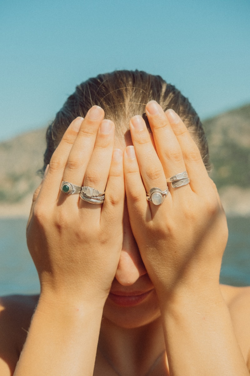 a woman covering her eyes with her hands