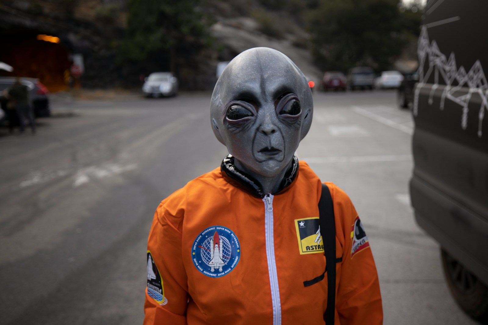 man in orange and white zip up jacket wearing white mask